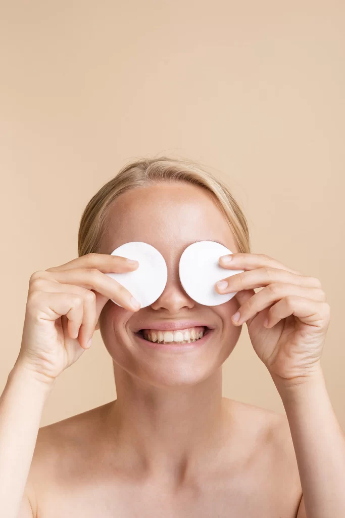 close-up-woman-covering-her-eyes-with-cotton-pads