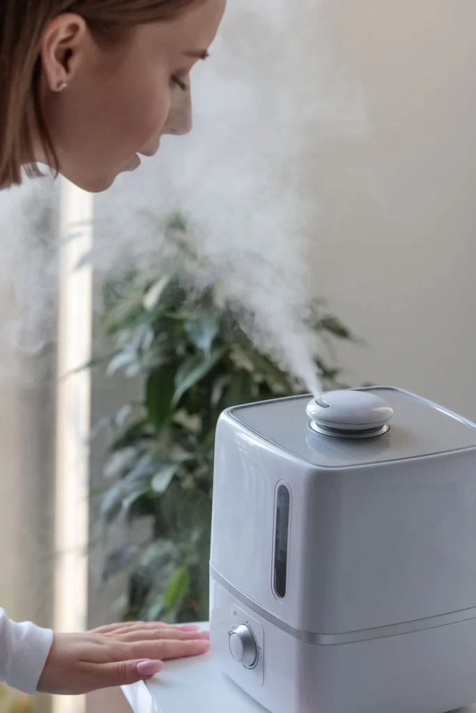 woman-turn-inhaling-aroma-oil-steam-from-humidifier